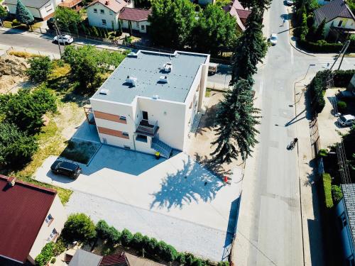 an aerial view of a white house with a swimming pool at Design Apartments in Ostrów Wielkopolski