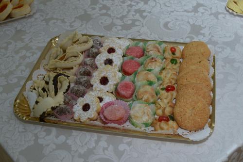 a tray of different types of pastries on a table at Le Tre Rose in Bono