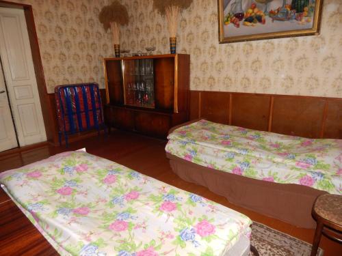 a room with two beds and a cabinet at Savanna House Jvari in Jvari