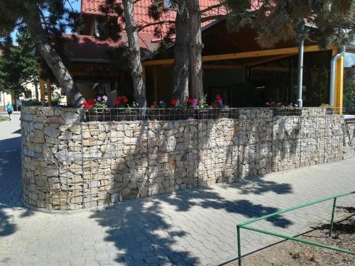 a stone wall with flowers on top of it at Hotel Zebetinsky Dvur Brno in Brno