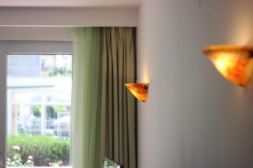 a piece of pizza hanging on a wall next to a window at Pirates Resort in Mamaia