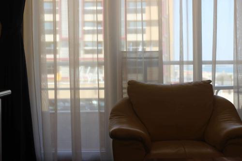 a couch sitting in front of a large window at Pirates Resort in Mamaia