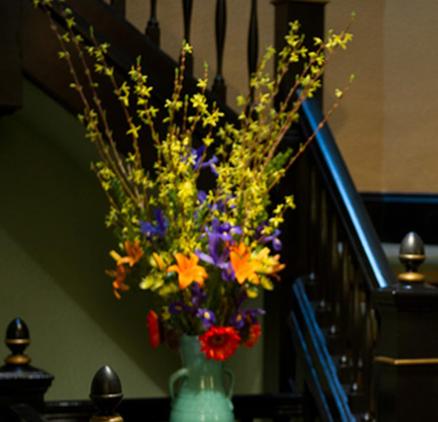 a vase filled with flowers on top of a table at Hotel Boheme in San Francisco