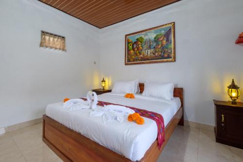 a bedroom with two beds and a painting on the wall at Latengaya Mount Batur View Bungalow in Kintamani