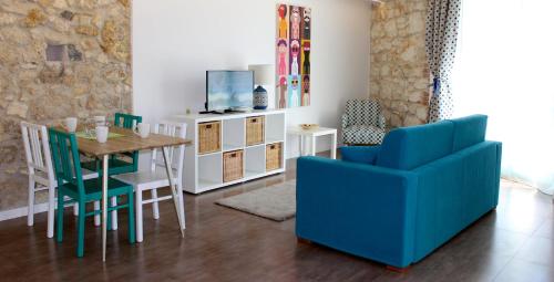 a dining room with a table and a blue chair at Archinuè in Siracusa