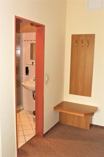 a bathroom with a sink and a toilet in a room at Hotel Alsterquelle in Henstedt-Ulzburg
