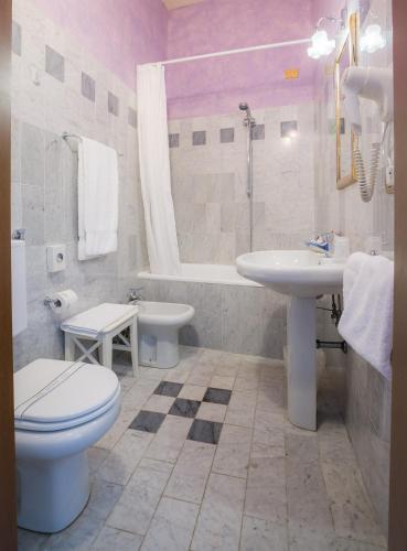 a bathroom with a toilet and a sink and a tub at Hotel Torre Guelfa Palazzo Acciaiuoli in Florence