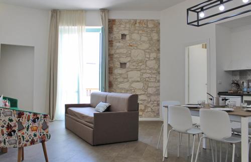 a living room with a couch and a table at Archinuè in Siracusa
