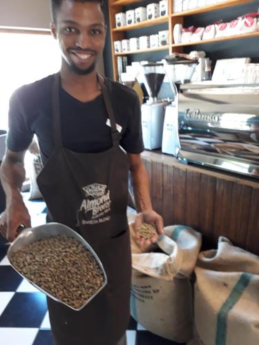 a man holding a tray of coffee beans at The Lighthouse Guesthouse in Colesberg