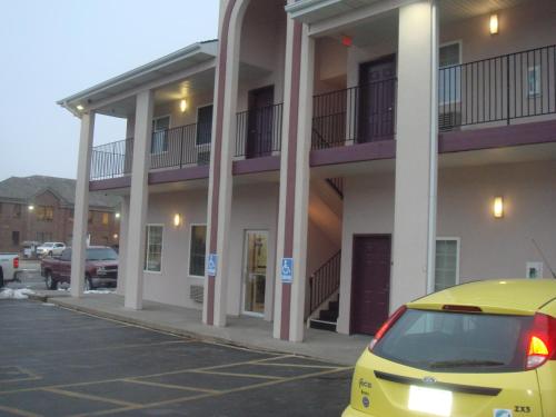 a yellow car parked in front of a building at Townhouse Inn & Suites Omaha in Omaha
