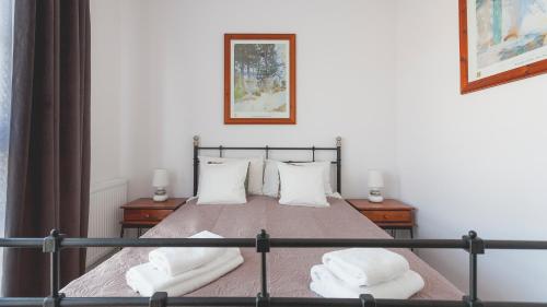 a bedroom with a bed with two white pillows at GRANO APARTMENTS Gdańsk Motława SPA & Wellness in Gdańsk