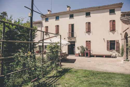 an exterior view of a large white building at La Luna nel Pozzo in Parma