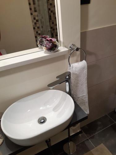 a bathroom with a white sink and a mirror at Charmy Rovinj in Rovinj
