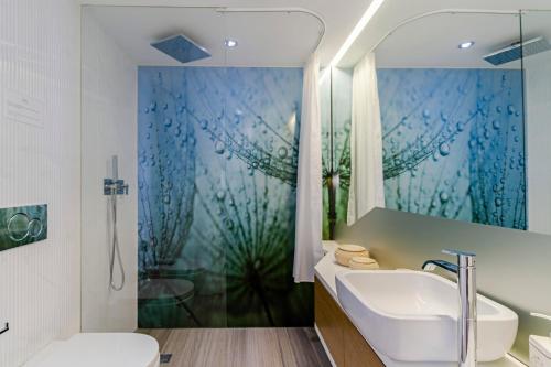 a bathroom with a tub and a sink and a shower at Baía I by An Island Apart in Funchal