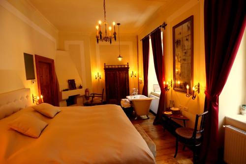 a bedroom with a large bed and a sink at Zabola Estate - Transylvania in Zăbala