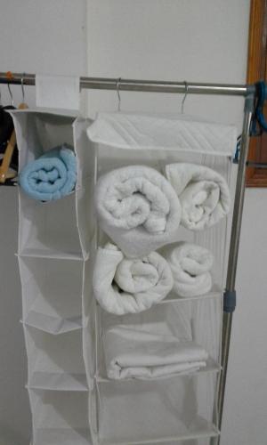 a towel rack with white towels on it at Edificio Ambay Roga in Asuncion