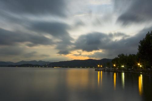 a view of a lake with a cloudy sky at Huachen International Hotel in Hangzhou