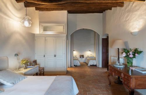 a bedroom with a bed and a dresser and a room at Can Mora de Dalt in Sant Vicenç de Montalt