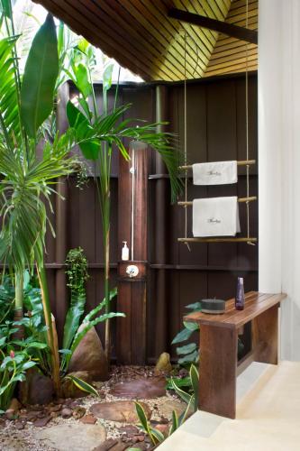 a room with a table and some plants at Shantaa Resort, Kohkood in Ko Kood