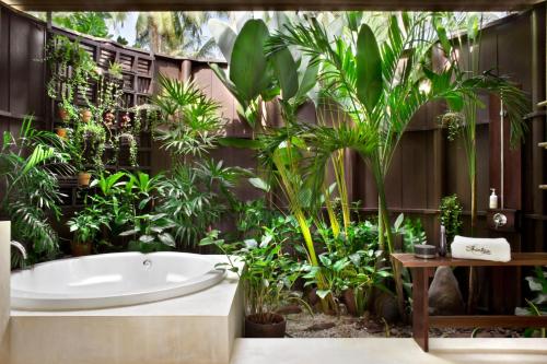a bathroom with plants and a bath tub at Shantaa Resort, Kohkood in Ko Kood