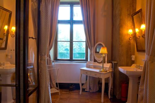 a bathroom with a sink and a mirror and a window at Zabola Estate - Transylvania in Zăbala