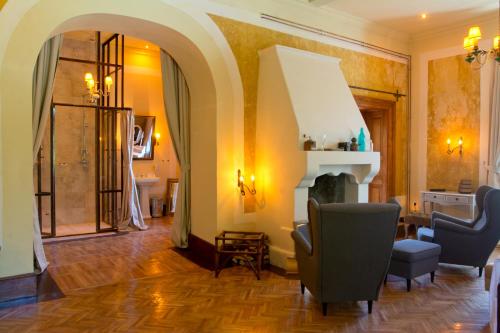 a living room with two chairs and a fireplace at Zabola Estate - Transylvania in Zăbala