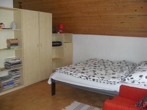 a bedroom with a bed and a book shelf at Alena Hutarova -Chalupa Bzince pod Javorinou in Dolní Bzince