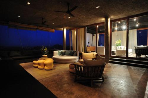 a living room with a couch and a chair at Sala Khaoyai in Wangkata