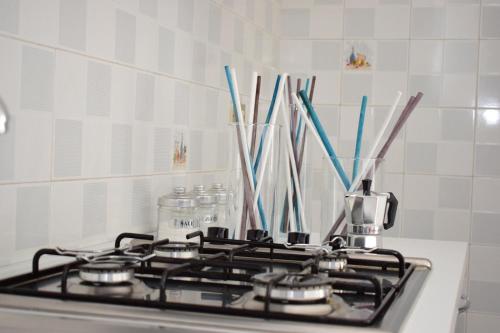 a stove top with some utensils in a kitchen at La Casa di Carta in Borgo Bonsignore