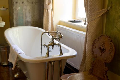 a bathroom with a sink and a window and a tub at Zabola Estate - Transylvania in Zăbala