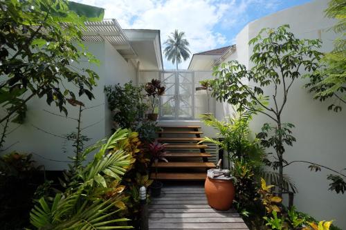 a courtyard with plants and stairs in a house at Shantaa Resort, Kohkood in Ko Kood
