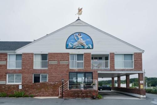 a building with a sign on the top of it at Ocean Club on Smuggler's Beach in South Yarmouth