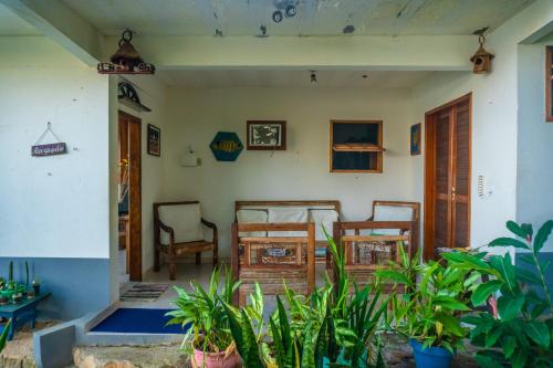 a room with chairs and a table in a house at Pousada Piquara in Mangaratiba