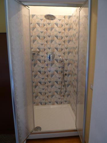 a shower with a glass enclosure in a bathroom at Hotel Alexander in Tropea