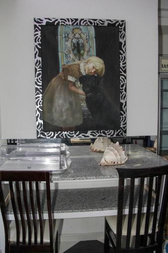 a painting of a woman with a dog on a table at Republika Hotel in Sarandë