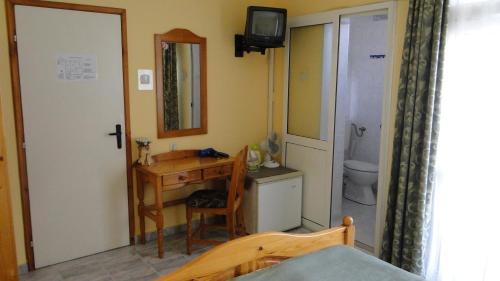 a bathroom with a sink and a desk and a toilet at Stemak Hotel in Pomorie