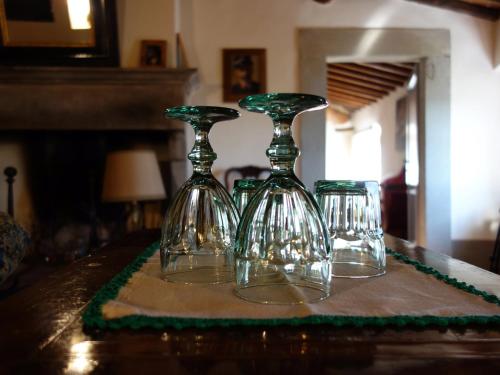 two glass wine glasses sitting on top of a table at Bella di Ceciliano in Arezzo