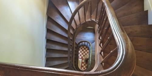 a spiral staircase in a building with wooden floors at Chambres d'Hôtes-Château Constant in Bessines-sur-Gartempe