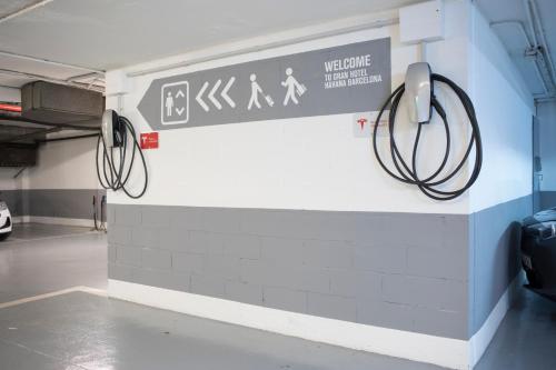 a sign on a wall in a parking garage at Gran Hotel Havana 4Sup by Escampa Hotels in Barcelona