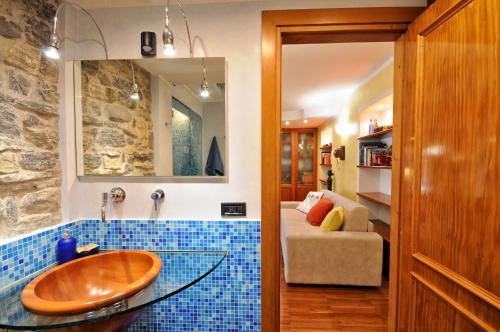 bagno con lavandino in legno e piastrelle blu di Crotto Polirolo - The House Of Travelers a Cernobbio