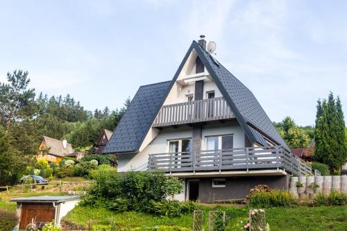 a house with a gambrel roof at Prázdninový dům Dolce II in Trutnov