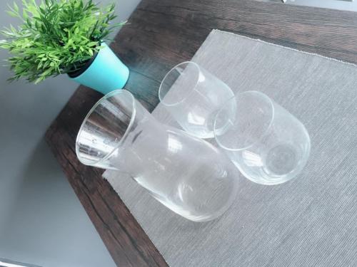 four wine glasses sitting on a table with a vase at SHAHALAM ALLBESS@TREFOIL in Setia Alam