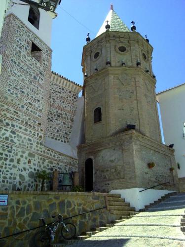 a building with a tower and stairs in front at Hotel Posada del Bandolero in Borge