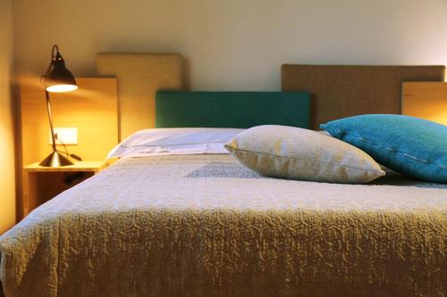 a bedroom with a bed with pillows on it at Mostofiore in Conegliano