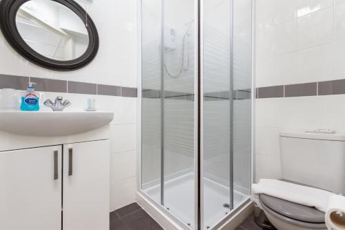 a bathroom with a shower and a toilet and a sink at Adelaide Lodge - Town Centre - Opposite Winter Gardens in Blackpool