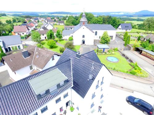 an aerial view of a small town with a church at Fast Lane Hotel in Barweiler