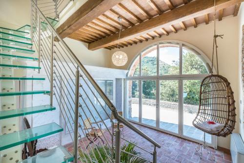 a room with a spiral staircase and a window at B&B Pietra a Padule in Filettole