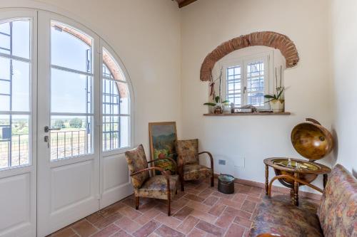 a living room with a door and a table and chairs at B&B Pietra a Padule in Filettole