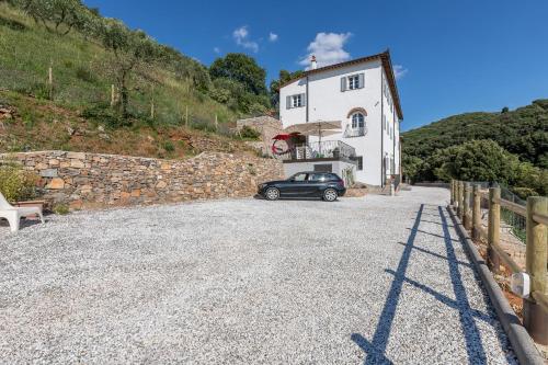 a car parked in front of a white building at B&B Pietra a Padule in Filettole