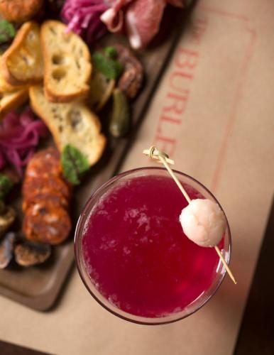 a drink in a glass next to a plate of food at Kennebunkport Inn in Kennebunkport